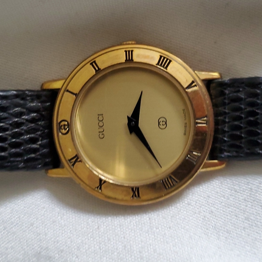 Authentic vintage Gucci watch gold and brown straps.
